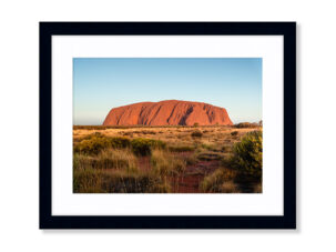 A framed photography print of Uluru at sunset.
